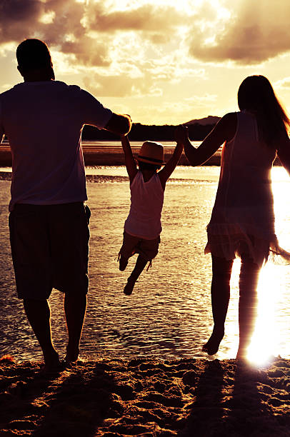 istock Parents swing child in air 483425075