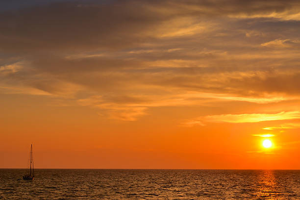 Ship sailing at dusk stock photo