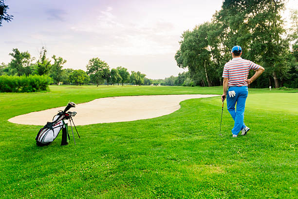 istock Beautiful golfing scenery with a golfer holding a club 483426070