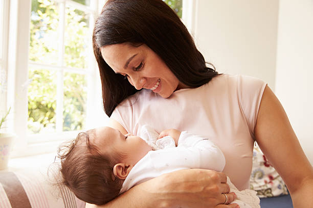 istock Mother Holding Sleeping Baby Boy At Home 483426662