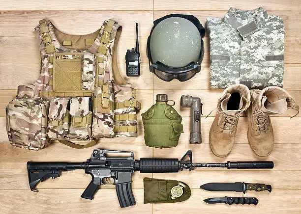 set of military equipment of the 21st century on a wooden background