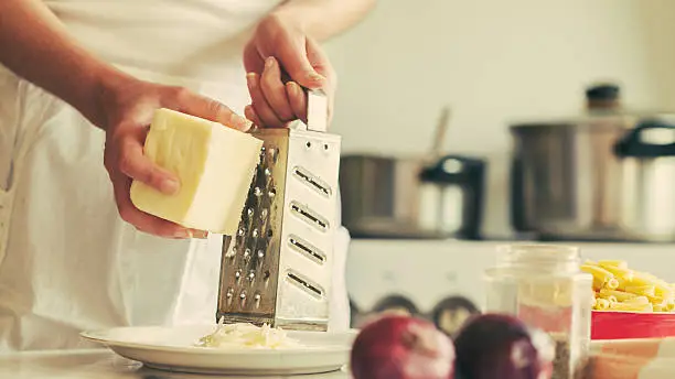 young woman grating cheese