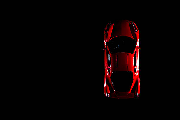 Izmir, Turkey - August 1, 2015: Red sports car like ferrari but not. Its brandless. On a black background and low key image.