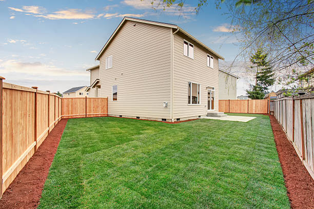 istock fenced and unfurnished back yard with grass. 483430722