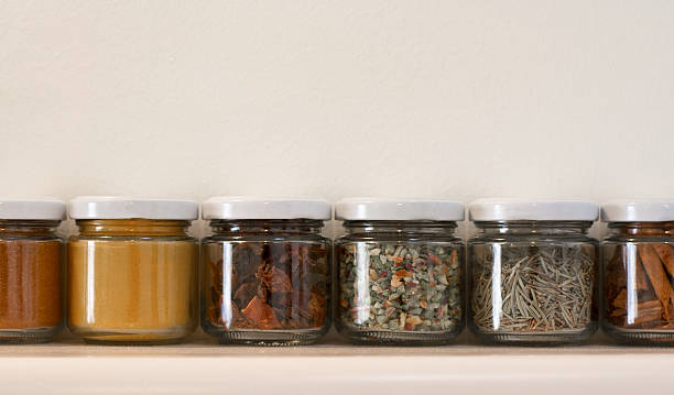 istock Colorful Jars of Spices Against Broad White Wall 483430758