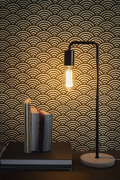 Edison filament table lamp and books home interior Edison filament table lamp and books contemporary home interior amber black photography stock pictures, royalty-free photos & images