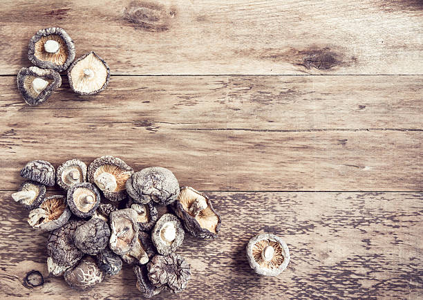 istock Dried shiitake mushrooms on wooden background. 483431048