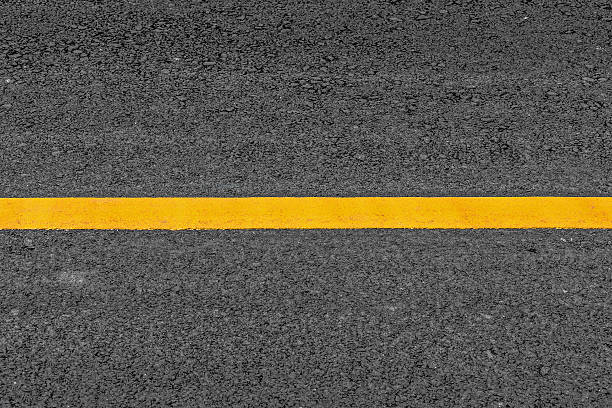 istock Yellow line on asphalt texture road background with grainy 483431242