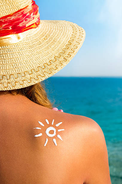istock Beautiful girl with  sun tan cream on her back 483431444