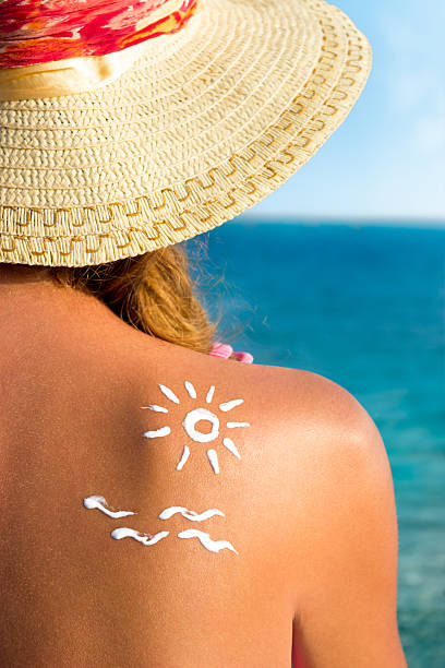 istock Sunscreen lotion over tan woman skin made as sun shape 483431506
