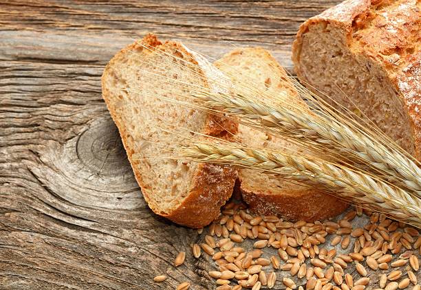 istock fresh bread and wheat on wooden background 483431884