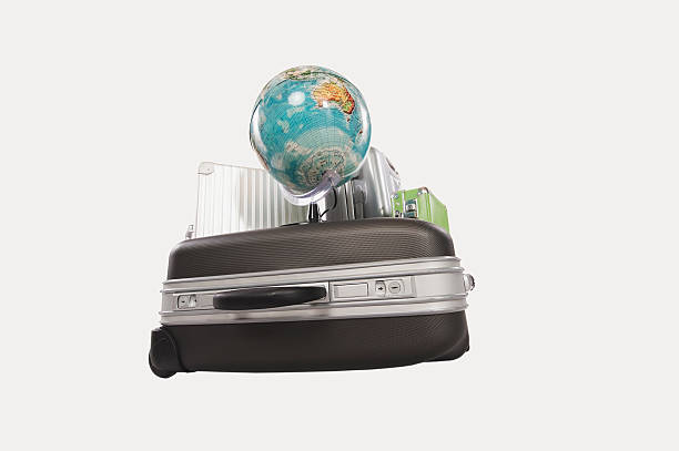 istock Suitcases and luggages with globe against white background 483435136