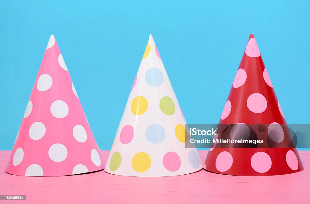 Bright party polka dot party hats Bright party polka dot party hats on modern pink and blue background. Party Hat Stock Photo