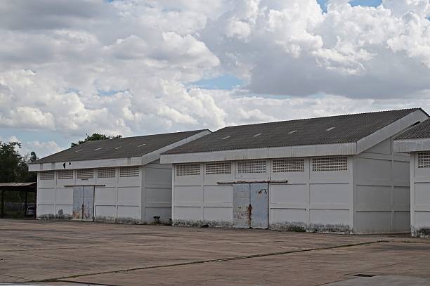 istock white warehouses in cloudy day 483436760