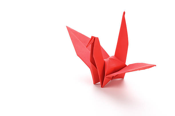 istock red bird origami on white background. 483437398