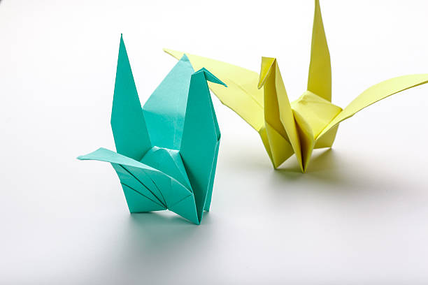 istock Green bird origami on white background. 483437412
