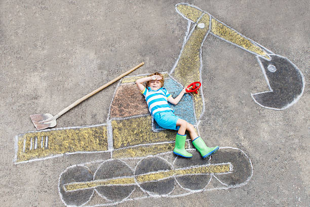 istock Happy funny little kid boy having fun with excavator picture 483445452