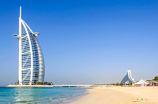 View of Burj Al Arab hotel from the Jumeirah beach Dubai, United Arab Emirates - January 08, 2012: View of Burj Al Arab hotel from the Jumeirah beach. Burj Al Arab is one of the Dubai landmark, and one of the world's most luxurious hotels with 7 stars. dubai stock pictures, royalty-free photos & images
