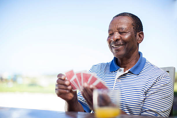 istock African senior playing a game of cards 483447921