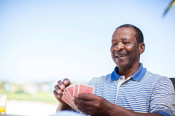 istock African senior playing a game of cards 483447955