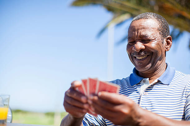 istock African senior playing a game of cards 483447971