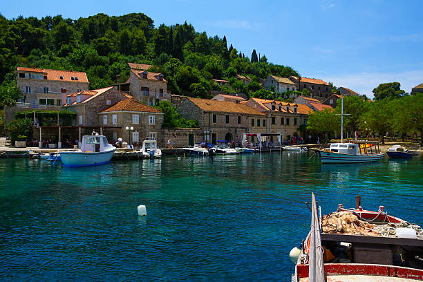 Sudurad, Croatia - June 27, 2015: Scene of the fishing port, with boats, locals and tourists, in the village Sudurad, Sipan Island, one of the Elaphiti Islands, Croatia