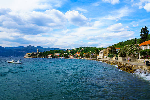 Lopud Beach and Port Lopud, Croatia - June 27, 2015: Scene of the fishing port and the beach, with the Franciscan Monastery, boats, locals and tourists, in the village Lopud, Lopud Island, one of the Elaphiti Islands, Croatia dubrovnik lopud stock pictures, royalty-free photos & images