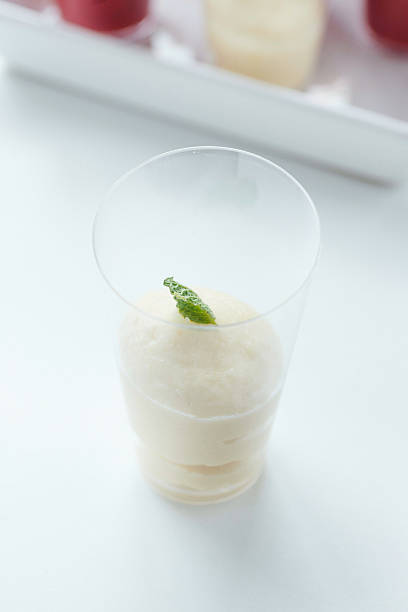 istock Vanilla mousse in a shot glass garnished with mint leaf. 483449006