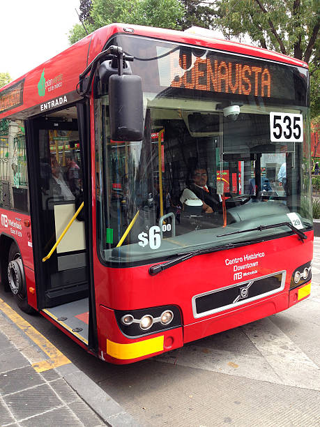 Mexico City, Mexico- December 10, 2013: View of the front and driver of a BRT Line 4 bus, a low-floor model, heading to Buenavista terminal, at a bus stop in the city's downtown. Mobilestock image.