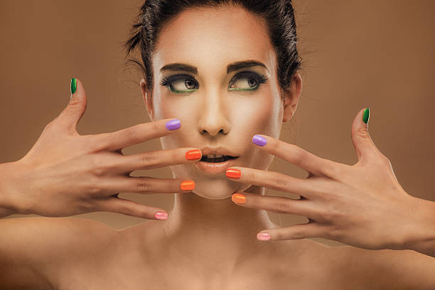 istock Face and hand with nails in different color. 483450519