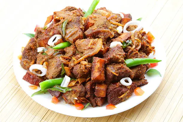 Indian meat fry served on plate.