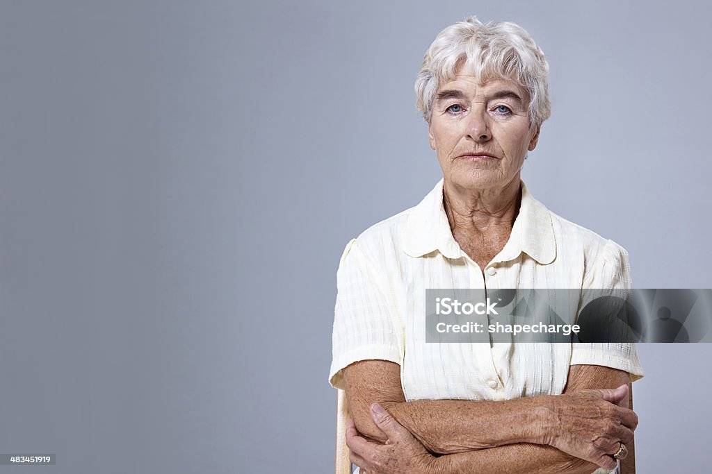I've lived a full life Studio portrait of a senior woman sitting with her arms crossed against a gray background 70-79 Years Stock Photo