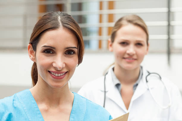 istock Smiling nurse and doctor standing 483453419