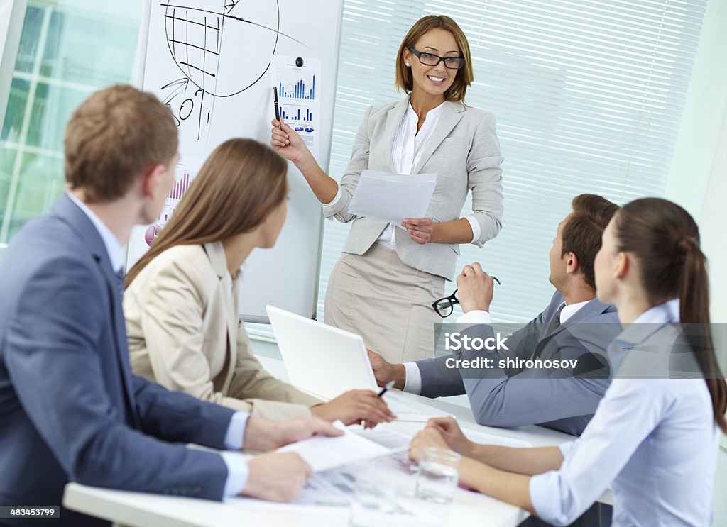 Working seminar Confident businesswoman explaining something to colleagues at meeting Adult Stock Photo