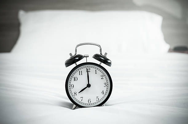 istock Vintage alarm clock on the bed 483457676