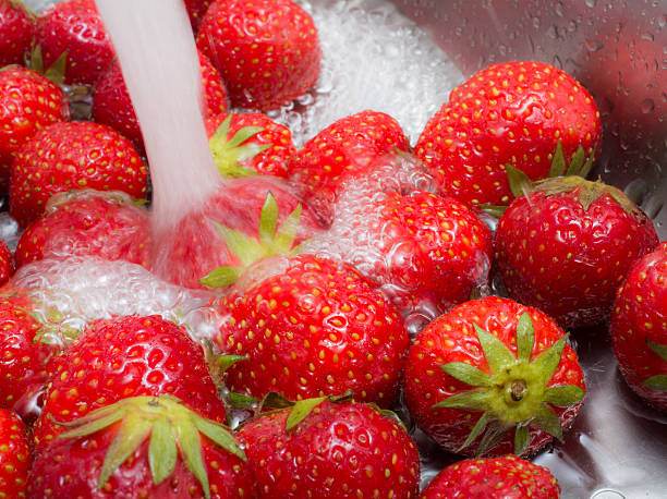 Washing strawberries under running water
