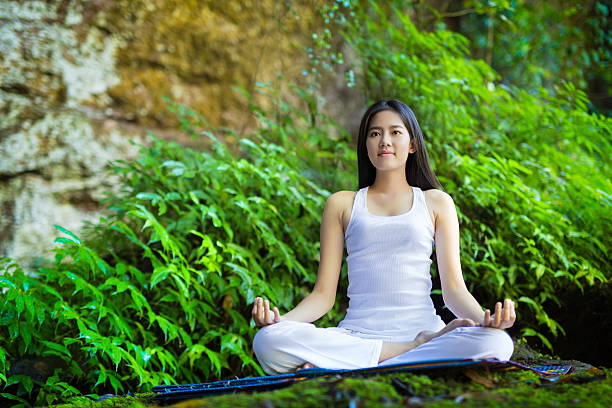 istock Asian woman doing yoga in forest 483458170