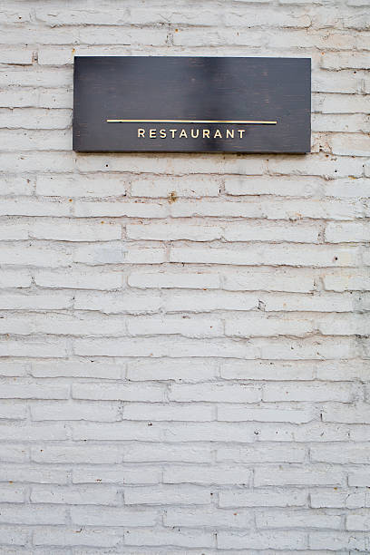 istock restaurant sign on black marble board on white brick wall 483458314