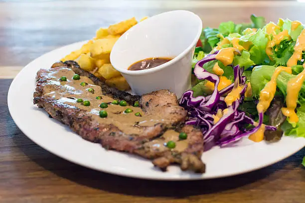 Photo of Grilled beef steak with salad and french fries