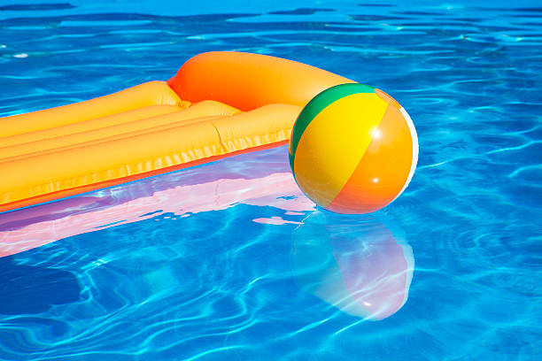inflatable raft and  colorful ball  on pool