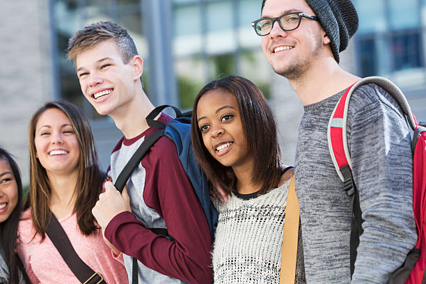 istock Group of students standing in a row outdoors 483465494