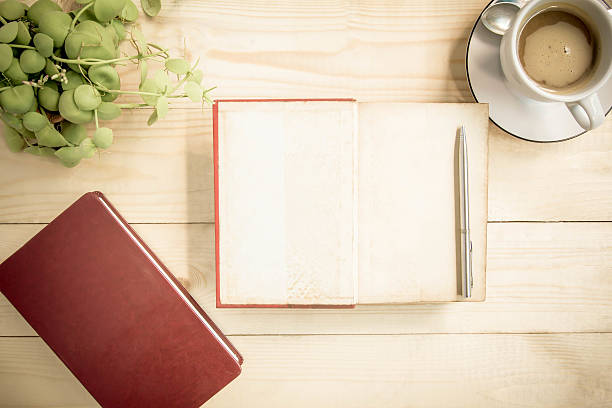 istock Open notebook diary on wooden table with coffee, Vintage Style. 483465562