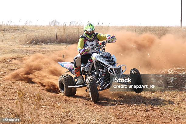 Quad Bike Kicking Up Trail Of Dust At Rally Stock Photo - Download Image Now - 2015, Activity, Authority