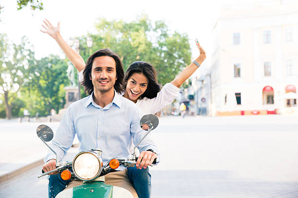 istock Cheerful couple riding on a scooter 483466344