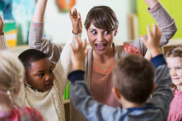 istock Teacher and children having fun in kindergarten class 483468132