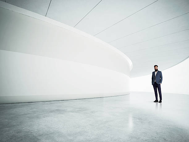 istock Young business man in the blank white interior 483468508