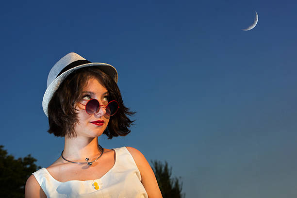 istock Cool young lady with a hat, looking at Blue Moon 483471618
