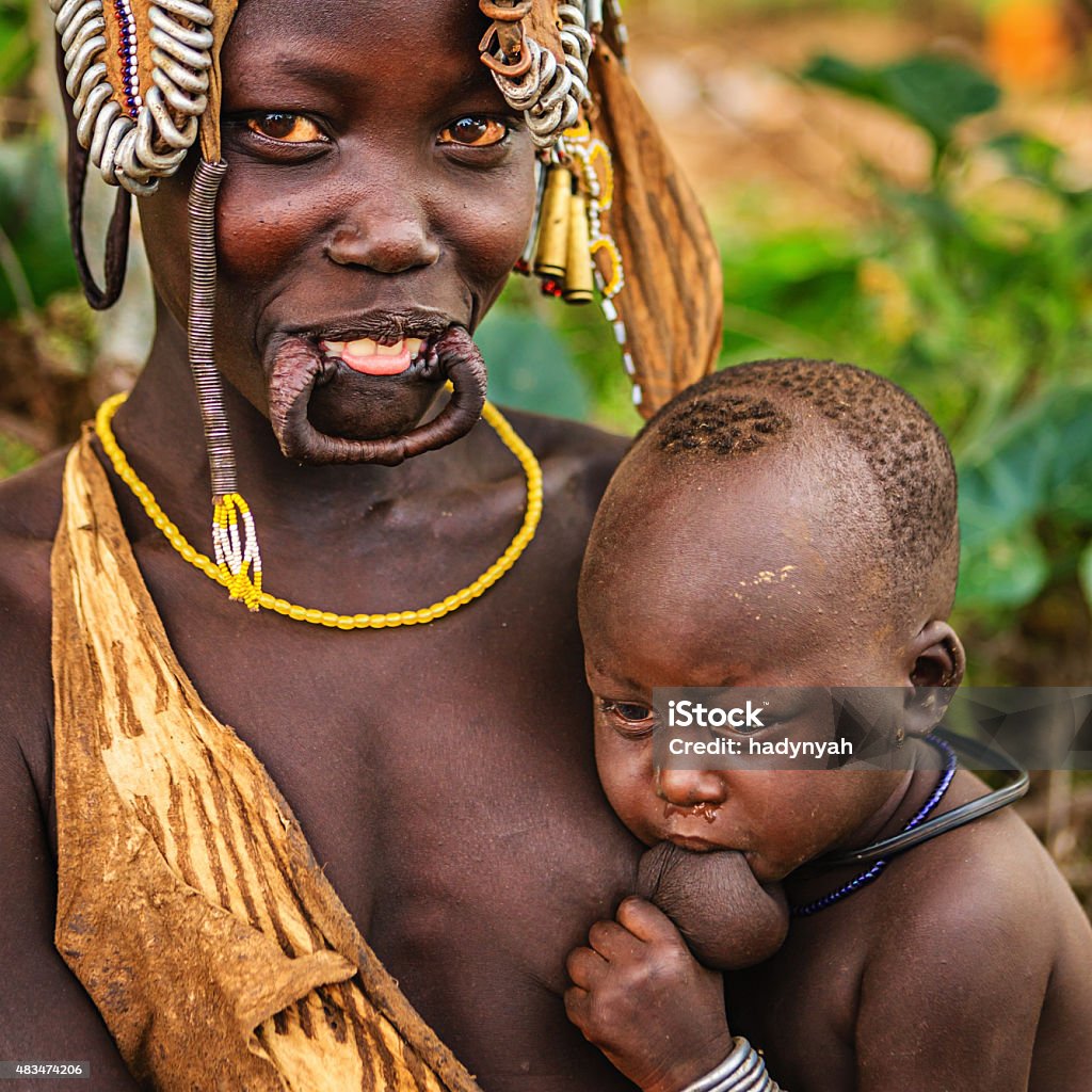 Woman From Mursi Tribe Breastfeeding Her Baby Ethiopia Africa Stock Photo -  Download Image Now - iStock