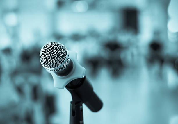 istock Close up of microphone in conference room on blurred background 483474936