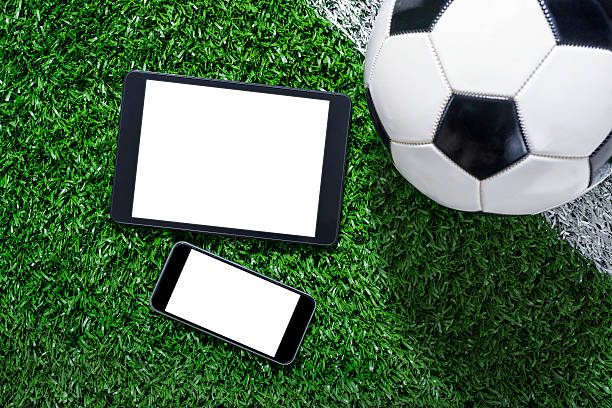 istock Smart Phone and Digital tablet in front of soccer ball 483474986